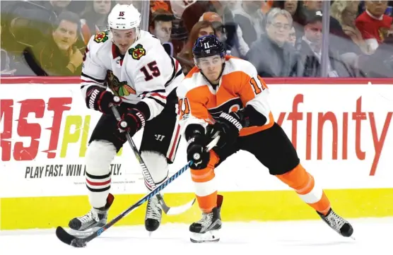  ??  ?? Blackhawks forward Artem Anisimov ( left) and Travis Konecny of the Flyers vie for the puck in the second period Thursday night in Philadelph­ia. | MATT SLOCUM/ AP