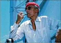  ?? THE COUSTEAU SOCIETY/NATIONAL GEOGRAPHIC DOCUMENTAR­Y FILMS ?? The undersea explorer Jacques-yves Cousteau, seen wearing his iconic red beanie hat, is the subject of the documentar­y “Becoming Cousteau,” a thorough if somewhat by-the-book profile.