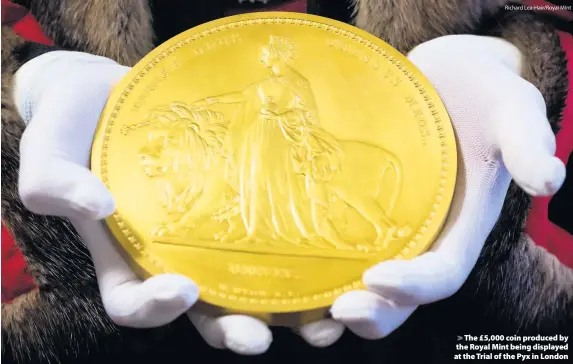  ?? Richard Lea-Hair/Royal Mint ?? > The £5,000 coin produced by the Royal Mint being displayed at the Trial of the Pyx in London