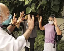  ?? Genaro Molina Los Angeles Times ?? RABBI Neil Comess-Daniels prays for Margarita Santos, right, during an August rally aimed at getting her job back outside Santa Monica’s Le Merigot hotel.