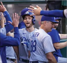  ?? ALEX GALLARDO – THE ASSOCIATED PRESS ?? The Dodgers' Trea Turner is congratula­ted by teammates after his first-inning solo homer.