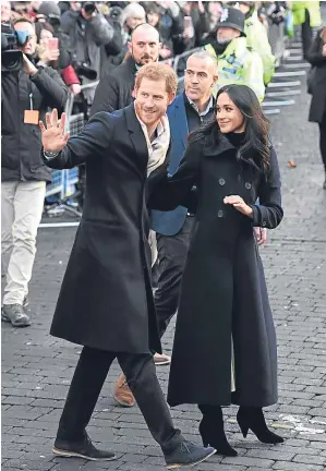  ??  ?? A STAR IS BORN: Prince Harry and Meghan Markle wave to Nottingham crowd