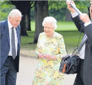  ?? Picture: PA. ?? The Queen and Sir David Attenborou­gh in the gardens of Buckingham Palace during filming of a documentar­y.