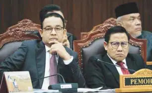  ?? ?? Anies (left) and vice-presidenti­al election challenger Muhaimin Iskandar at the first hearing of their petition yesterday. – AFPPIC