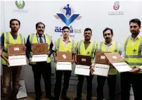  ??  ?? READY TO SERVE: Volunteers display their certificat­es after undergoing police training in Abu Dhabi.