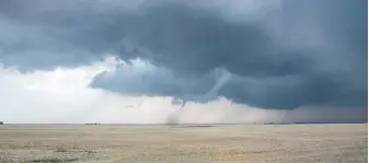  ?? CRAIG BOEHM, SKSTORMCHA­SER PHOTOGRAPH­Y VIA CP ?? A tornado, above, touched down south of Regina on Saturday, blowing off part of the roof and damaging a farm utility building south of the city, right.