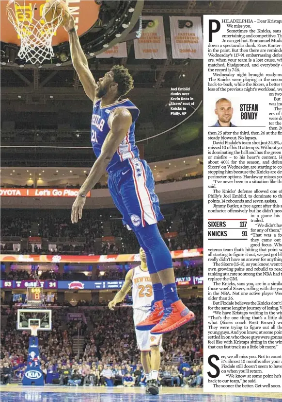  ??  ?? Joel Embiid dunks over Kevin Knox in Sixers’ rout of Knicks in Philly. AP