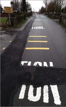  ?? Photo byJohn Reidy ?? The semi obliterate­d school warning road markings on Castleisla­nd’s busy College Road.