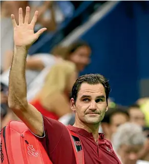  ?? AP ?? Roger Federer bids farewell to the 2018 US Open after his shock defeat in the third round to fired up Australian John Millman, left.