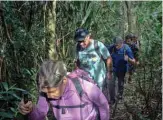  ??  ?? People walk along a hiking trail - part of a projected 8,000kilomet­er trail across Brazil.
