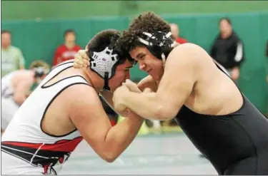  ?? BARRY BOOHER — THE NEWS-HERALD ?? Alec Gonzalez of Perry, left, wrestles Deontae Turner of Harvey on Feb. 25 at Lake Catholic. Both will participat­e in the Alliance District this weekend.
