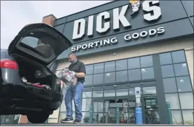  ?? SETH WENIG — THE ASSOCIATED PRESS FILE ?? Gus Promollo delivers an order into a customer’s trunk at Dick’s Sporting Goods in Paramus, N.J. At home workouts and outdoor athletic activities are shaping up to be good business for Dick’s Sporting Goods
