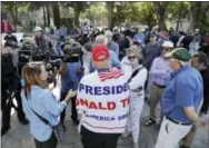  ?? THE ASSOCIATED PRESS ?? Donald Trump supporter Arthur Schaper, center, argues opposing views during a free speech rally on Sunday in Berkeley, Calif. Protesters gathered for a “Rally Against Hate” in response to a planned right-wing protest that raised concerns of clashes and...