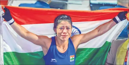  ??  ?? (Above) Indian boxer Mary Kom gets emotional as she celebrates after winning the final match of light flyweight 45-48kg against Ukraine’s Hanna Okhota at AIBA Women’s World Boxing Championsh­ips in New Delhi on Saturday and (top-left) posing with her Gold medal