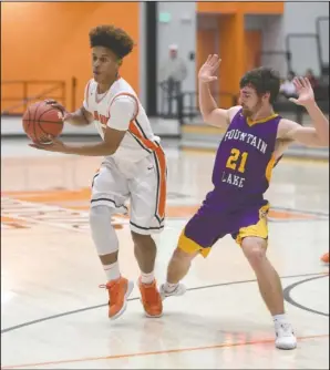  ?? The Sentinel-Record/Mara Kuhn ?? LEOPARD ON THE LOOSE: Malvern guard B.J. Francis (left) drives past Fountain Lake’s Joe Murphy (21) Thursday night at the Leopard Center. The Leopards won 57-52, improving to 7-2 overall and 6-0 in conference.