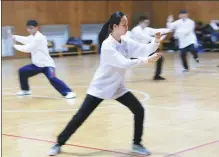  ?? PHOTOS BY WEI XIAOHAO / CHINA DAILY ?? More than 140 students from Peking University take part in a tai chi competitio­n at the campus in Beijing on Dec 23.