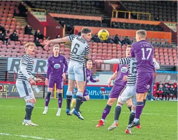  ?? ?? Stuart Morrison heads clear the danger in the first half for Queen’s Park