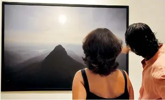  ??  ?? Stunning views: Guests at the exhibition opening take in the photograph­s. Pix by Indika Handuwala