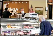  ?? JEN SAMUEL — MEDIANEWS GROUP ?? In this file photo, Daniel Boxler, owner of the Country Butcher, helps a customer in Kennett Square.