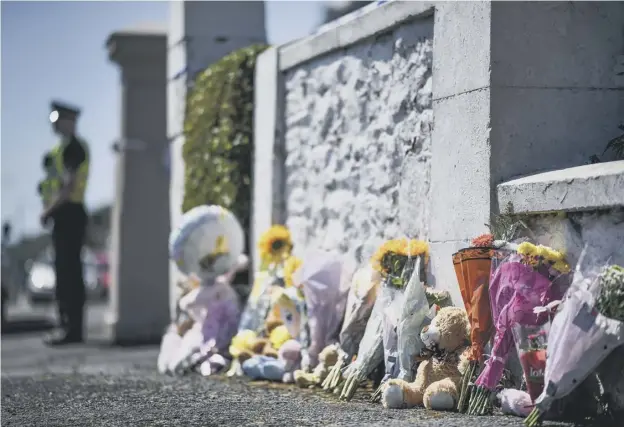  ??  ?? 0 Floral tributes, toys and balloons are left for six-year-old Alesha outside her grandparen­ts’ house on Ardbeg Road in Rothesay