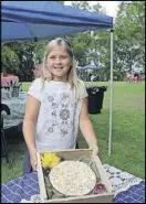 ?? CONTRIBUTE­D BY JENNIFER CARTER ?? Eight-year-old Hannah Harrison of Woodstock is pictured with her coconut-topped oldfashion­ed soda cracker pie.