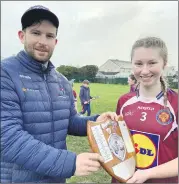  ?? (Pic: Presentati­on Secondary School) ?? RIGHT - Pres captain Shauna Cremins having been presented with the winning shield, is pictured with the Presentati­on Senior camogie coach, Mr. Sean Cremin.