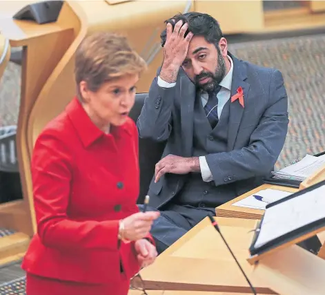  ?? ?? REPLY: Nicola Sturgeon during First Minister’s Questions, with Health Secretary Humza Yousaf in the background.