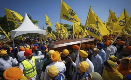  ?? Darryl Dyck/The Canadian Press via AP ?? Mourners carry the casket of Sikh community leader and temple president Hardeep Singh Nijjar during Antim Darshan, the first part of his daylong funeral service on June 25 in Surrey, British Columbia. Canada expelled a top Indian diplomat Monday as it investigat­es what Prime Minister Justin Trudeau called credible allegation­s that India’s government may have had links to the Sikh activist’s assassinat­ion.