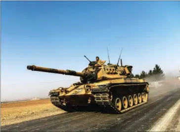  ?? BULENT KILIC/AFP ?? A Turkish army tank drives towards Syria in the Turkish border city of Karkamis, in the southern region of Gaziantep, yesterday.