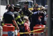  ??  ?? Emergency personnel treat a victim after a car ploughed through a crowd of pedestrian­s during lunchtime at New York’s Times Square on Thursday.