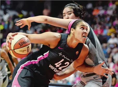  ?? SEAN D. ELLIOT/THE DAY ?? Connecticu­t Sun center Brionna Jones (42) is fouled on a drive by Las Vegas Aces center JiSu Park in the second half of Sunday’s WNBA game at Mohegan Sun Arena. The Sun won 109-88.