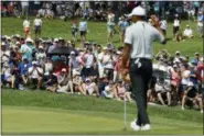  ?? CHARLIE RIEDEL — THE ASSOCIATED PRESS ?? Fans cheer after Tiger Woods made par on the sixth hole Friday in St. Louis.