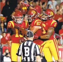  ?? ?? USC QUARTERBAC­K Caleb Williams (13) is congratula­ted by teammates after scoring a first-quarter touchdown.