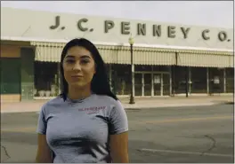  ?? MADELINE TOLLE — THE FULLER PROJECT ?? Alexandra Orozco is seen outside of the closed J.C. Penney in Delano on Dec. 6. She was recently laid off from the store.