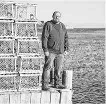  ?? DAVID JALA • CAPE BRETON POST ?? Scotchtown Volunteer Fire Department deputy chief Ashley Osborne stands on the wharf at Lingan Bay some 24 hours after venturing into the cold water in search of any people who may have been trapped in a submerged car.