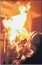  ??  ?? Protesters burn an effigy of Nepal's PM K P Sharma Oli in Kathmandu.
