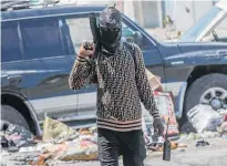  ?? Photo / AP ?? An armed gang member patrols in Port-auPrince.