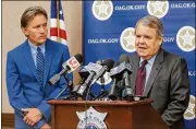  ?? CHRIS LANDSBERGE­R / THE OKLAHOMAN ?? Attorney Michael Burrage (right) with Attorney General Mike Hunter, announces the filing of a lawsuit against four of the nation’s leading manufactur­ers of opioids, June 30. The suits being filed by at least 25 states resemble tobacco-industry lawsuits...