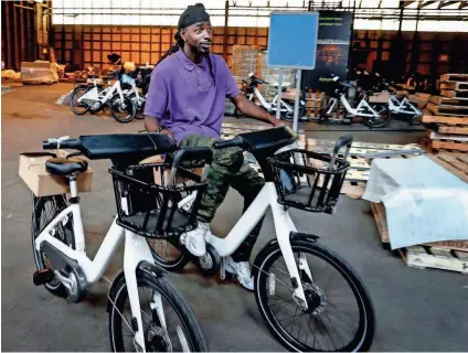  ??  ?? Cherance King tests assembled bikes, as Explore Bike Share staff put together 600 for-rent bicycles and 60 docking stations that will be placed around the city before their May 23 launch. MARK WEBER/THE COMMERCIAL APPEAL