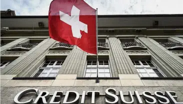  ??  ?? Big European bank: A Swiss flag flying over a sign of Swiss bank Credit Suisse in Bern. While Credit Suisse is still one of Europe’s largest investment banks, its main focus is managing money for wealthy entreprene­urs around the globe and especially in emerging markets. — AFP