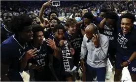  ?? Photograph: Patrick Smith/Getty Images ?? Saint Peter's players celebrate after their historic victory over Purdue at this year’s NCAA tournament.