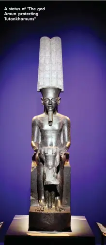  ??  ?? A status of "The god Amun protecting Tutankhamu­ns"