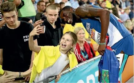  ?? GETTY IMAGES ?? Kyron McMaster, of the British Virgin Islands, celebrates with fans after winning the men’s 400m hurdles final at the Commonweal­th Games.
