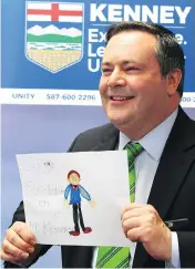  ?? JIM WELLS/POSTMEDIA ?? UCP leadership candidate Jason Kenney shows a drawing given to him after he cast his ballot on Thursday.