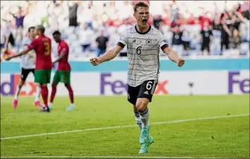  ?? Matthias Schrader / Getty Images ?? Midfielder Joshua Kimmich celebrates Germany’s second tally, an own-goal scored by Portugal defender Raphael Guerreiro in the first half at Euro 2020 in Munich on Saturday.