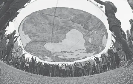  ?? PHILIPP GUELLAND/EPA-EFE ?? Protesters hold a banner outside last year’s United Nations climate change conference in Germany.