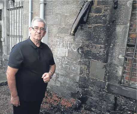  ??  ?? Jim Sturrock of Forte’s Cafe stands next to the sewage pipe which melted when a fire broke out.