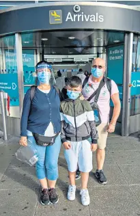  ??  ?? Gloria and John Salazar, with son Luis, arriving at Stansted from Barcelona