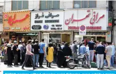  ?? — AFP ?? TEHRAN: Iranians, without observing social distancing, queue outside a money exchange office in the capital on Saturday.