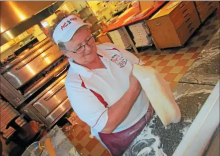  ?? PHOTOS SPECIAL TO THE DISPATCH BY MIKE JAQUAYS ?? Martha Oakes prepares a piece of dough for its transforma­tion into a tasty pizza July 5at Pepi’s Pizza in Oneida.
